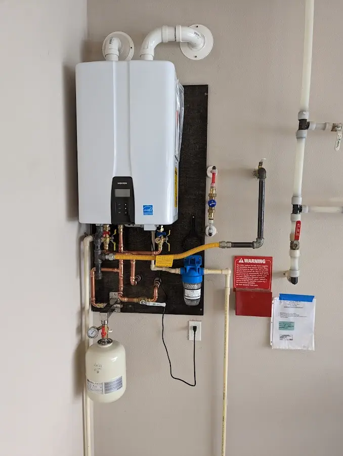 Professional plumber installing copper piping in a Ware home